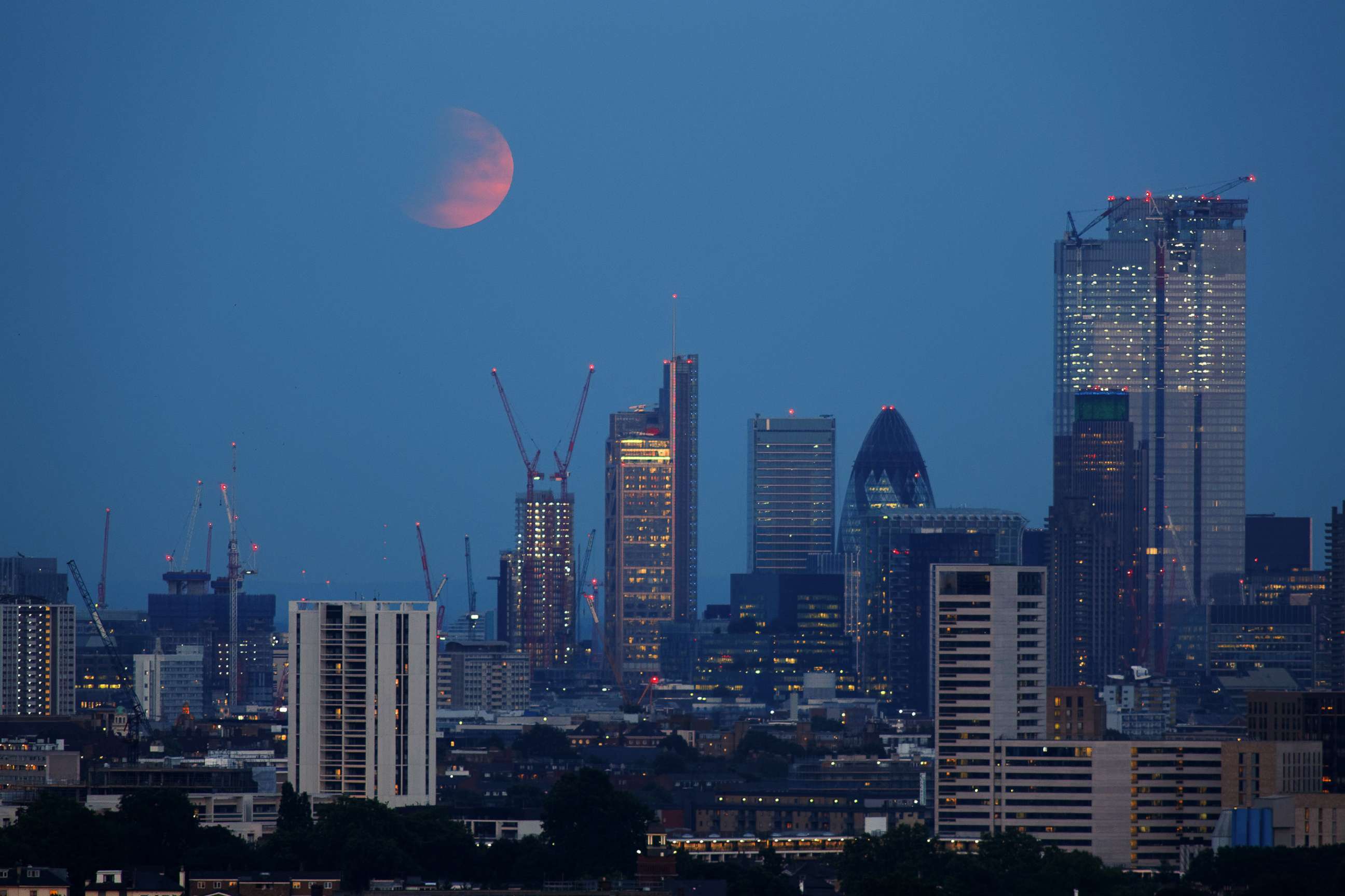 PHOTO: The moon over London during a partial lunar eclipse, July 16, 2019.
