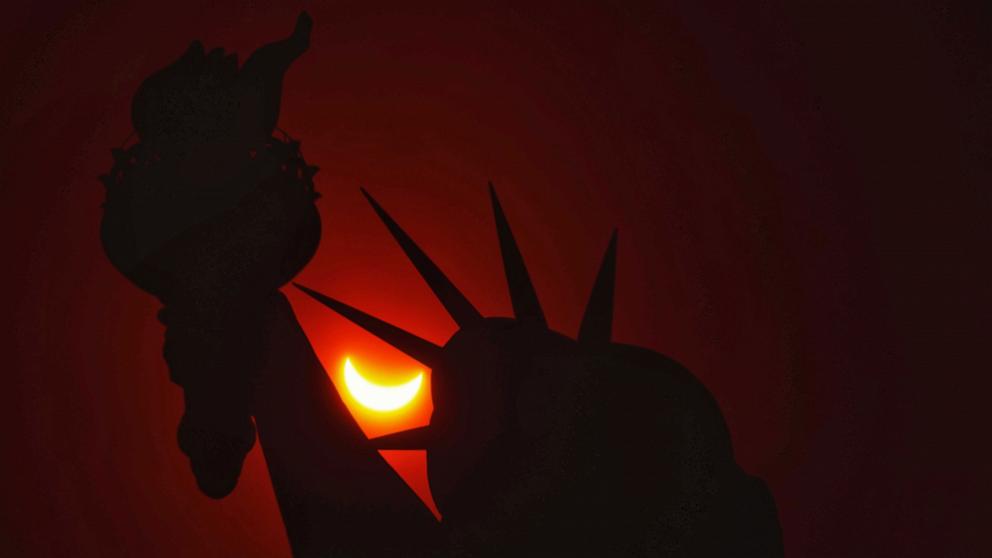 PHOTO: A partial eclipse shines through the Statue of Liberty, New York, April 8, 2024. 