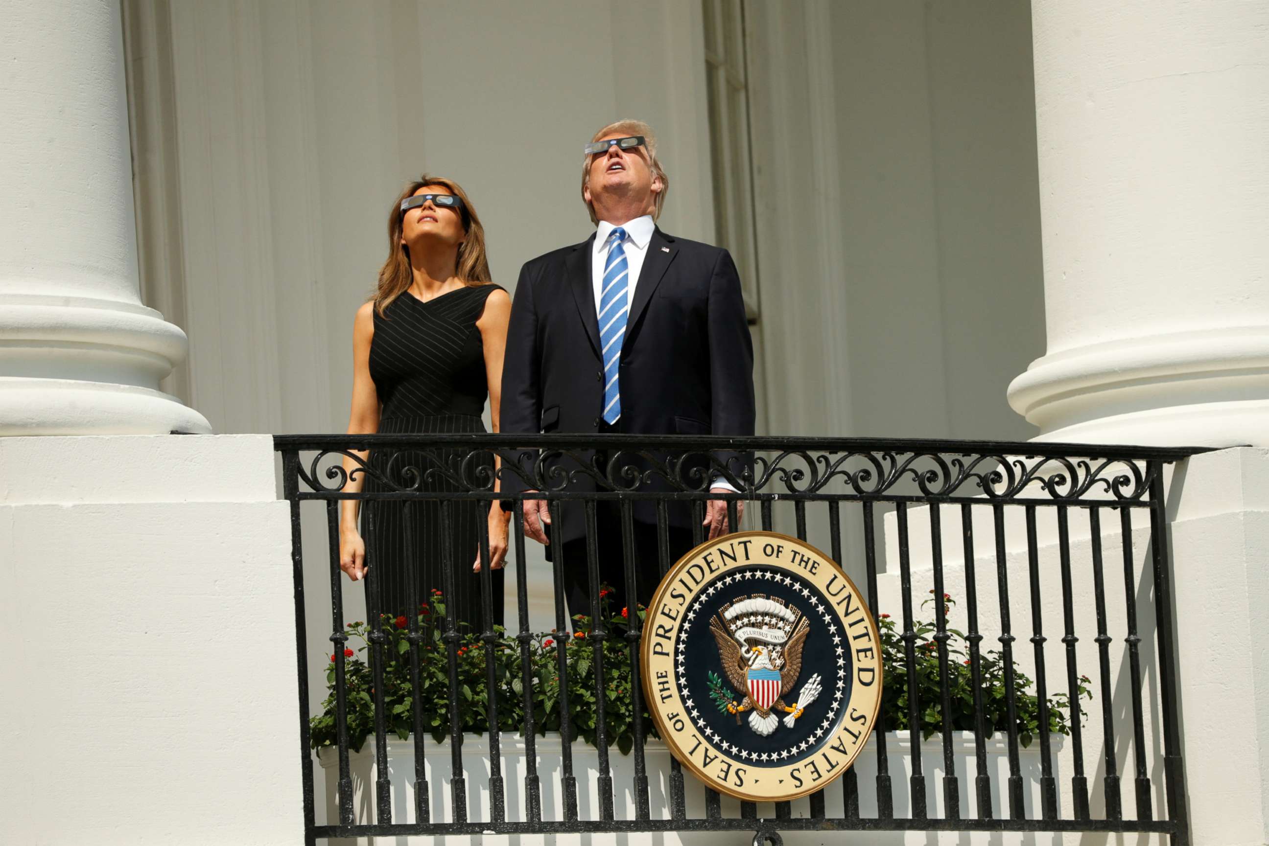 PHOTO: President Donald Trump watches the solar eclipse with first Lady Melania Trump from the Truman Balcony at the White House, Aug. 21, 2017. 