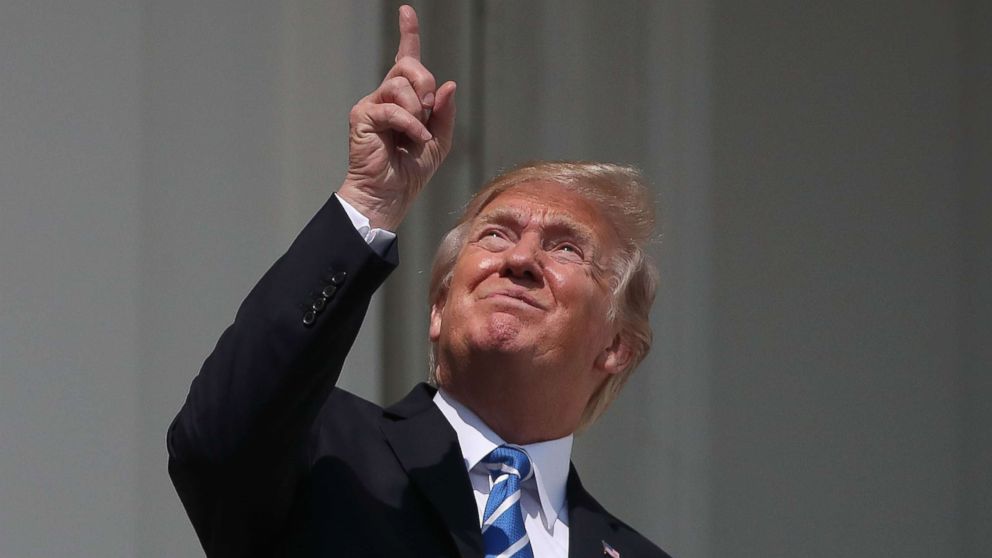 PHOTO: President Donald Trump looks up to view the solar eclipse on the Truman Balcony at the White House, Aug. 21, 2017.
