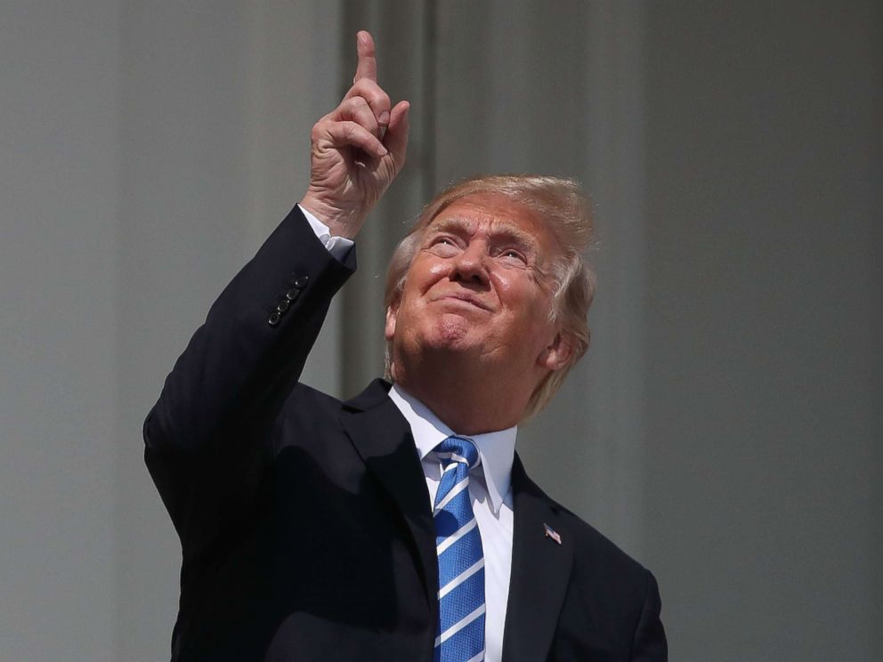 PHOTO: President Donald Trump looks up to view the solar eclipse on the Truman Balcony at the White House, Aug. 21, 2017.