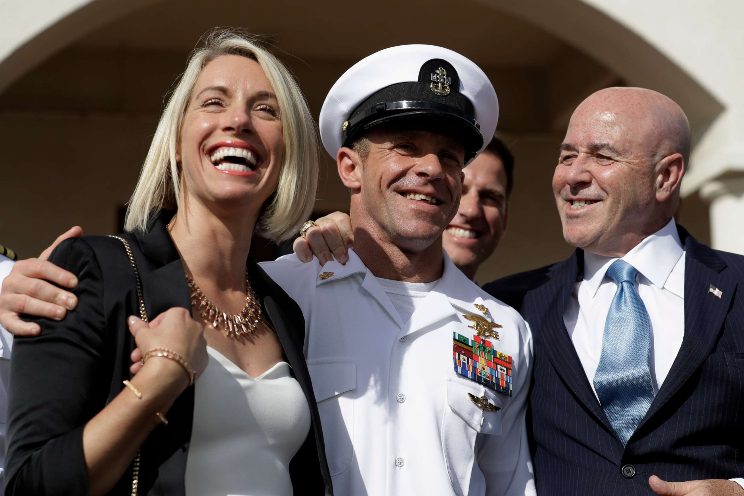 PHOTO: Navy Special Operations Chief Edward Gallagher, center, walks with his wife, Andrea Gallagher, left, and advisor, Bernard Kerik as they leave a military court on Naval Base San Diego, July 2, 2019, in San Diego.
