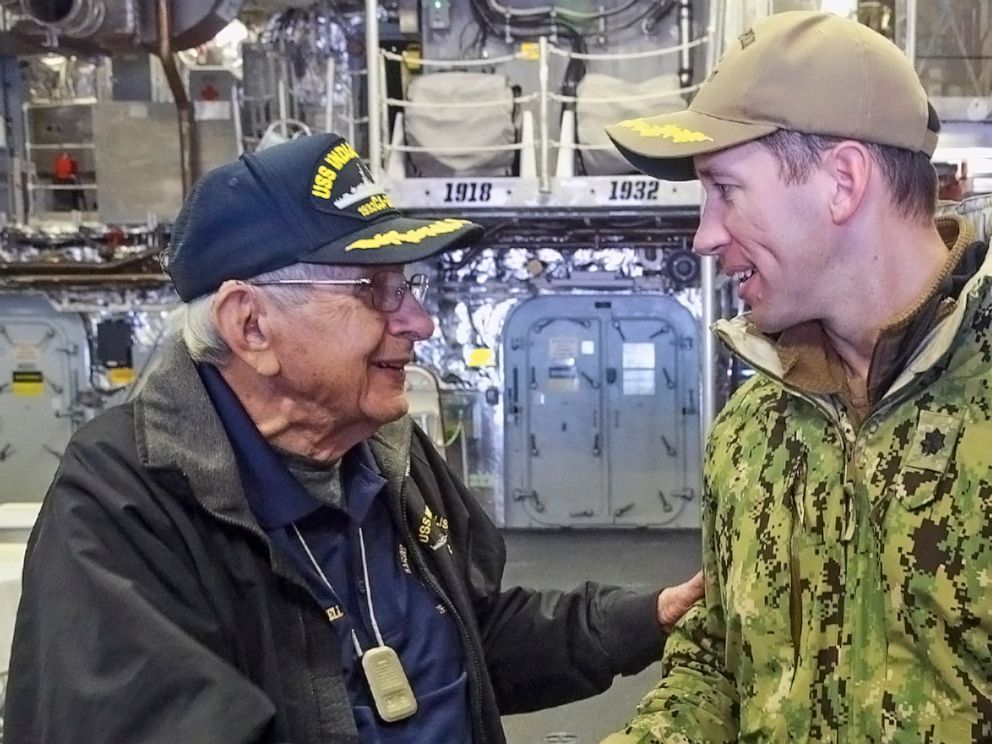 PHOTO: Sgt. Edgar Harrell, U.S. Navy (Ret.) shakes hands with Commander Colin Kane, soon to be commissioned as Captain of the USS Indianapolis, Oct. 24, 2019.