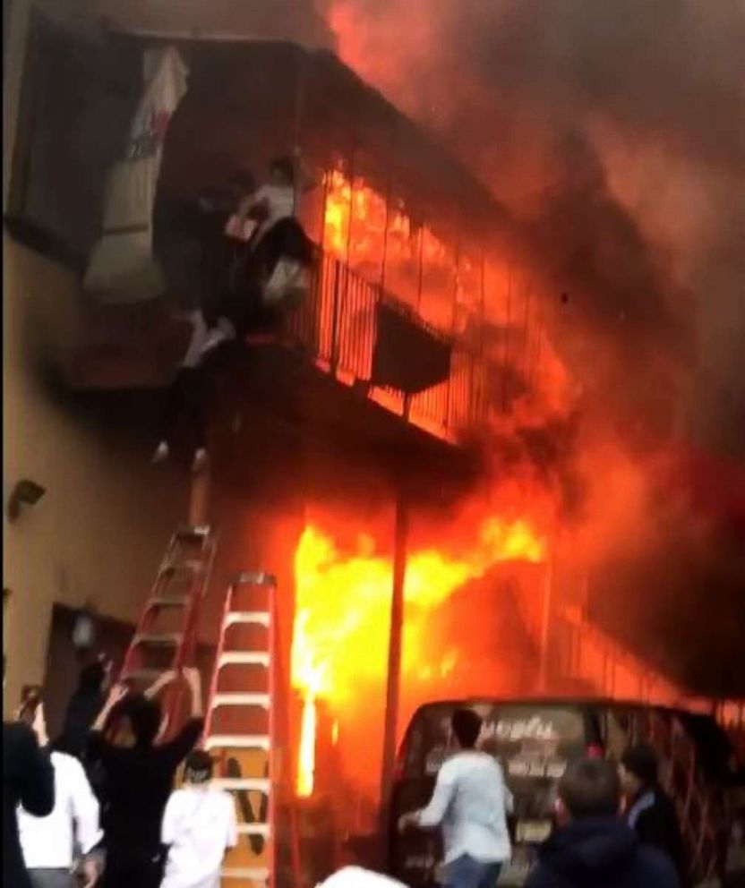Several members of a dance studio in Edgewater, N.J., were forced to escape when their building went up in flames, Monday, April 9, 2018.