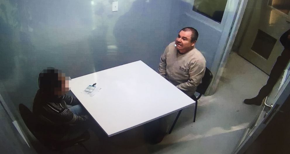 PHOTO: Handout picture released by the Mexican Interior Ministry on January 20, 2017, shows Joaquin Guzman Loera aka "El Chapo" Guzman, right, sitting in a chair as he is extradited to the United States on January 19, 2017, in an unknown location.  