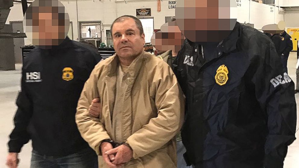 This file handout photo obtained, Jan. 20, 2017, released by the Mexican Interior Ministry, shows Joaquin Guzman Loera aka "El Chapo" Guzman escorted in Ciudad Juarez by the Mexican police as he is extradited to the United States.