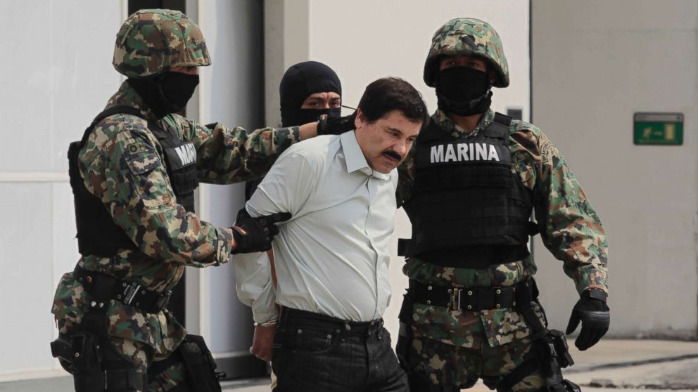 Joaquin 'El Chapo' Guzman, leader of Mexico's Sinaloa drug Cartel, was captured alive overnight in the beach resort town of Mazatlan, considered the Mexican most-wanted drug dealer, Feb. 22, 2014, in Mexico City. Guzman is escorted to a helicopter in handcuffs by Mexican navy marines at a navy hanger.