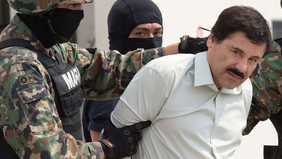 PHOTO: Joaquin "El Chapo" Guzman is escorted to a helicopter by Mexican security forces at Mexico's International Airport in Mexico city, Feb. 22, 2014. 