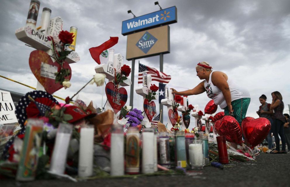 PHOTO: A woman touches a cross at a makeshift memorial for victims outside Walmart, near the scene of a mass shooting which left at least 22 people dead, on Aug. 6, 2019 in El Paso, Texas.