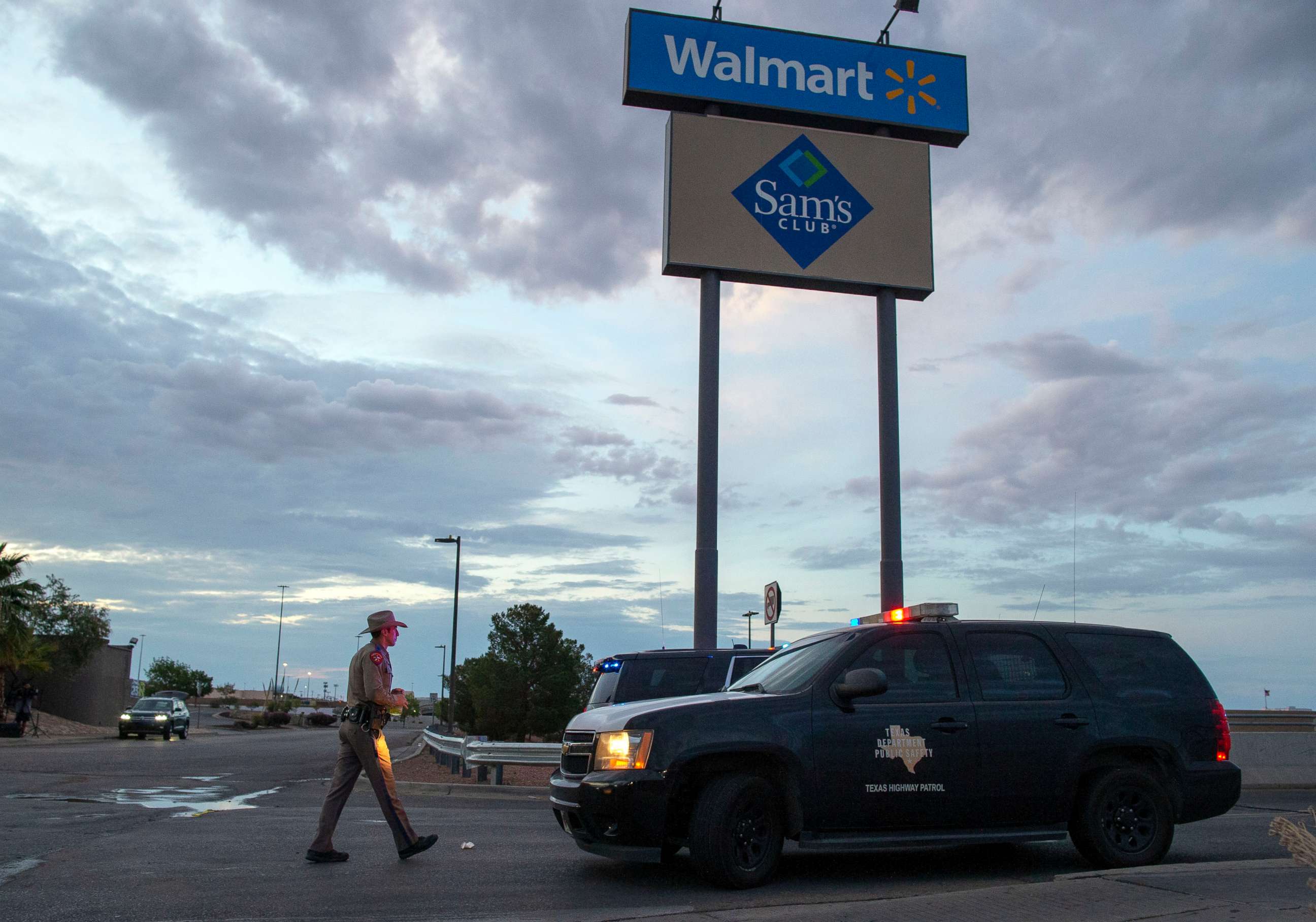 PHOTO:A Texas State Trooper walks back to his car while providing security outside the Walmart store in the aftermath of a mass shooting in El Paso, Texas, , Aug. 4, 2019. 