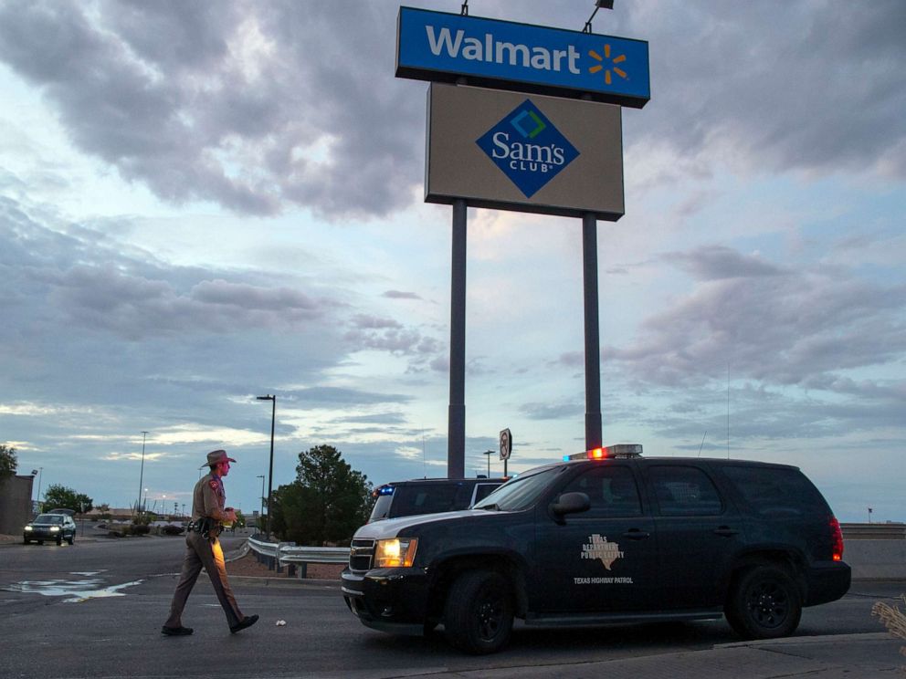 PHOTO:A Texas State Trooper walks back to his car while providing security outside the Walmart store in the aftermath of a mass shooting in El Paso, Texas, , Aug. 4, 2019.