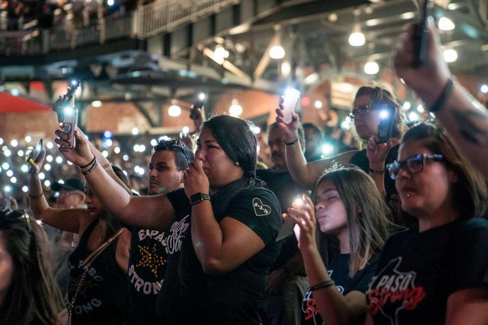 PHOTO: Attendees hold up the flashlights on their phones during a community memorial service for the 22 victims of the mass shooting at Southwest University Park in El Paso, Texas, Aug. 14, 2019.