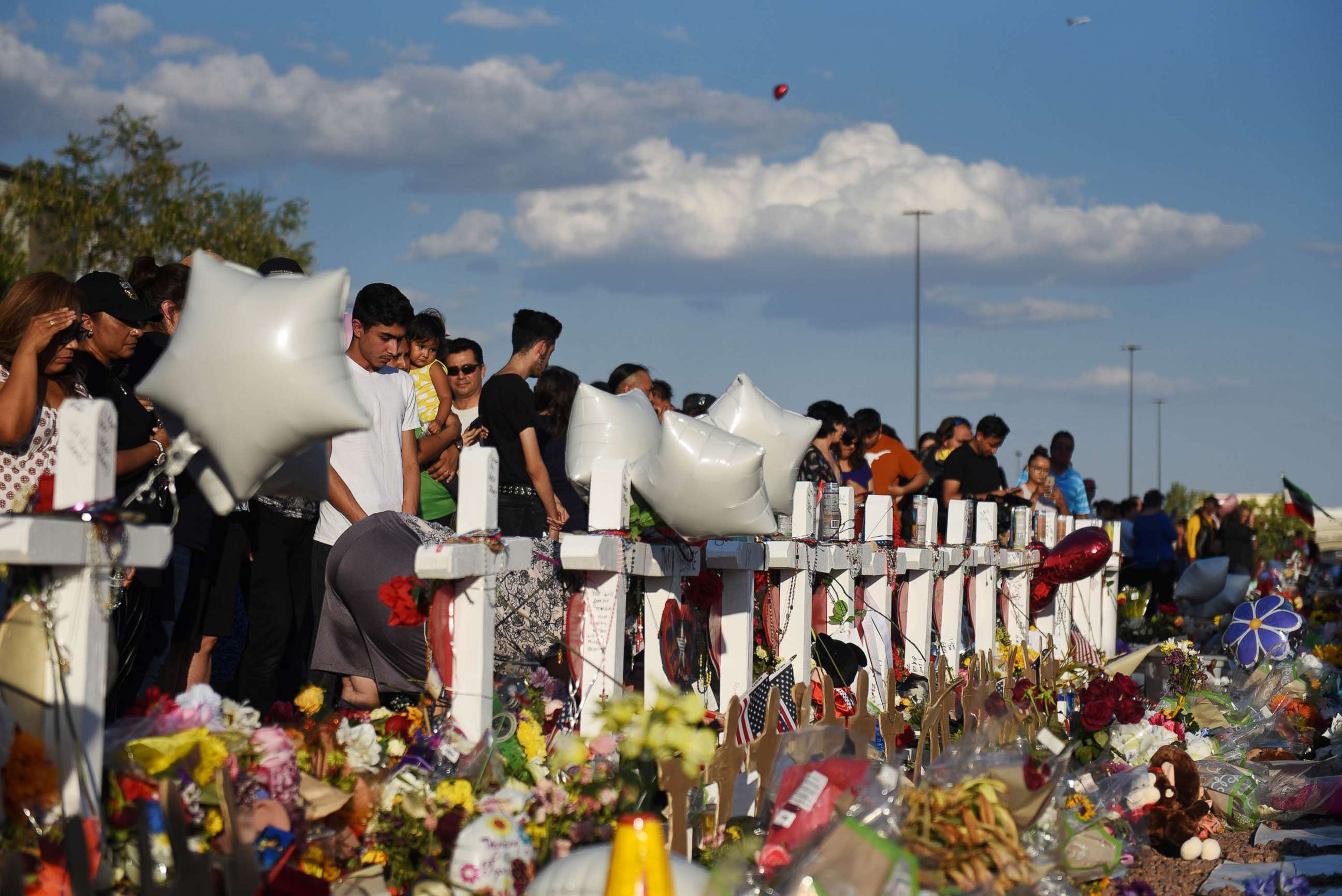 PHOTO: People gather to pay their respects at a growing memorial three days after a mass shooting at a Walmart store in El Paso, Texas, August 6, 2019