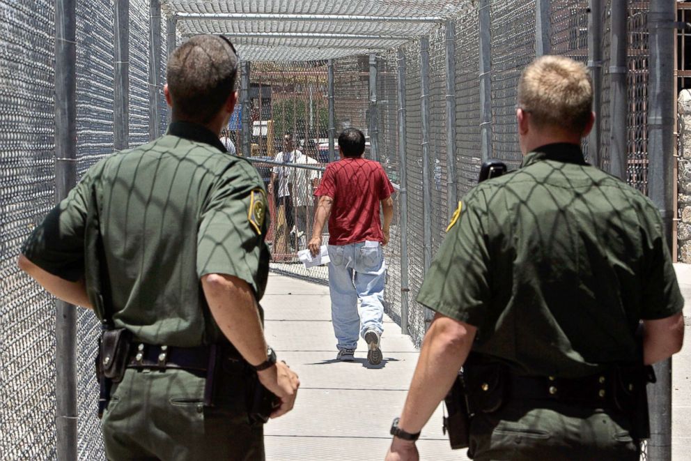 PHOTO: U.S. Border Patrol agents look on as a Mexican citizen leaves the Border Patrol Processing Center to be voluntarily repatriated, June 26, 2007, in El Paso, Texas.