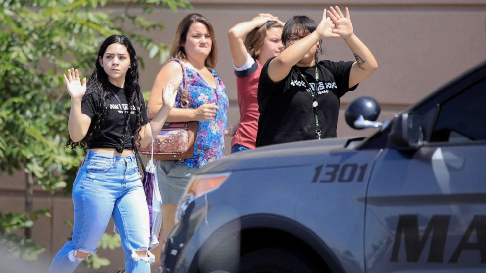 PHOTO: Shoppers exit with their hands up after a mass shooting at a Walmart in El Paso, Texas, Aug. 3, 2019.
