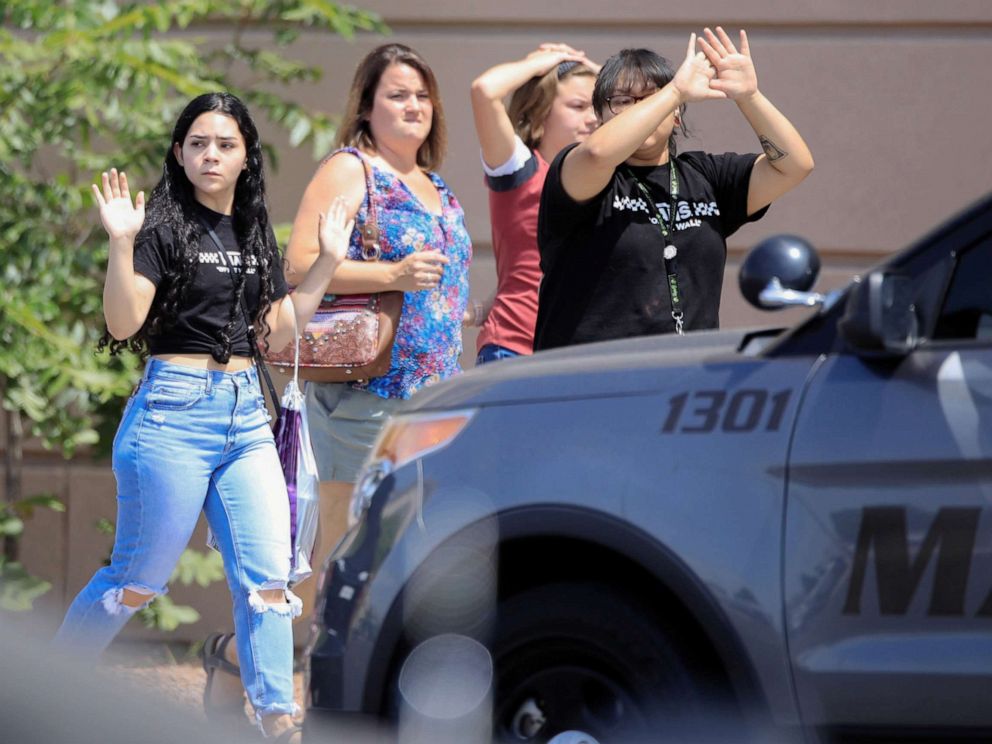 PHOTO: Shoppers exit with their hands up after a mass shooting at a Walmart in El Paso, Texas, Aug. 3, 2019.
