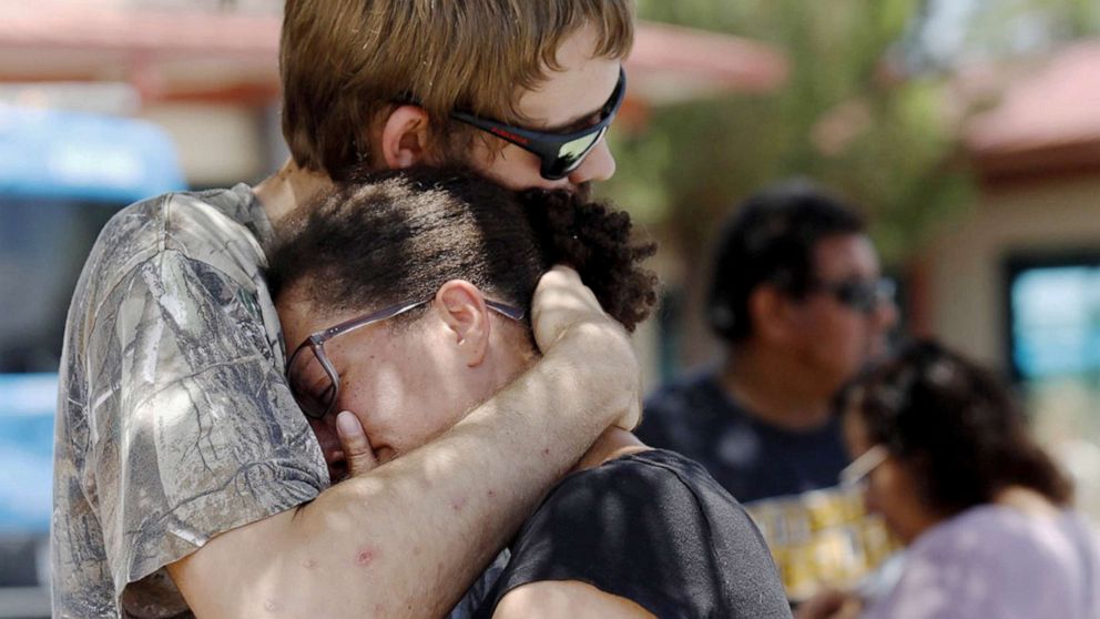 PHOTO:A man comforts a woman who was in the freezer section of a Walmart during a shooting incident, in El Paso, Texas, Aug. 03, 2019.