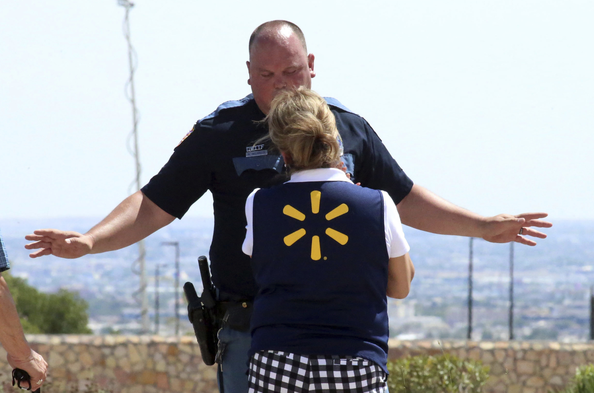 PHOTO: An El Paso police officer talks to a store employee following a shooting  at a shopping mall in El Paso, Texas, on Aug. 3, 2019.