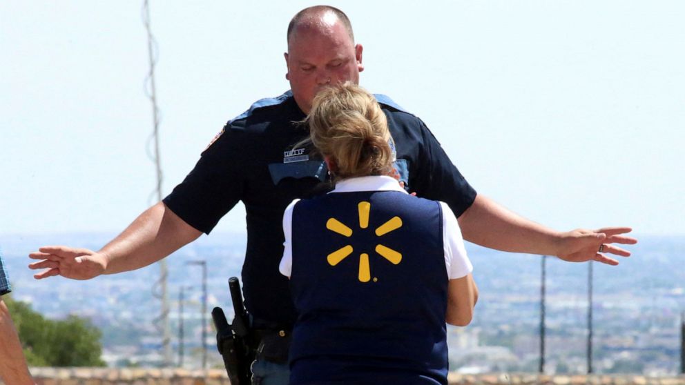 PHOTO: An El Paso police officer talks to a store employee following a shooting  at a shopping mall in El Paso, Texas, on Aug. 3, 2019.