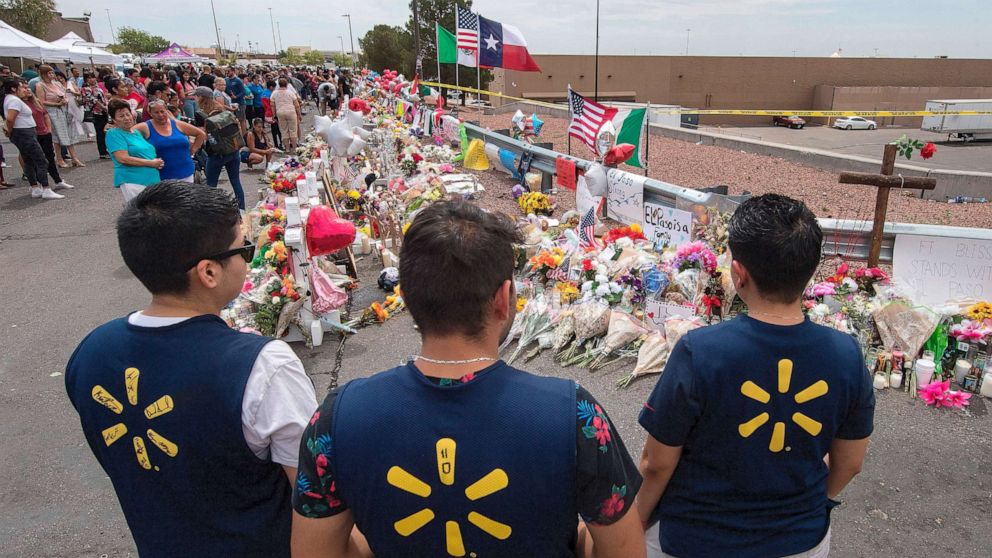 PHOTO: File photo: Walmart employees pay their respects at a makeshift memorial for the Aug. 3, 2019 shooting victims at the Cielo Vista Mall Walmart in El Paso, Texas, on Aug. 6, 2019.