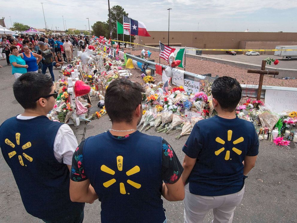 PHOTO: File photo: Walmart employees pay their respects at a makeshift memorial for the Aug. 3, 2019 shooting victims at the Cielo Vista Mall Walmart in El Paso, Texas, on Aug. 6, 2019.