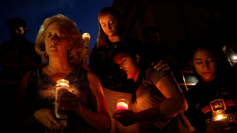 PHOTO: Mourners take part in a vigil at El Paso High School after a mass shooting at a Walmart store in El Paso, Texas, Aug. 3, 2019.