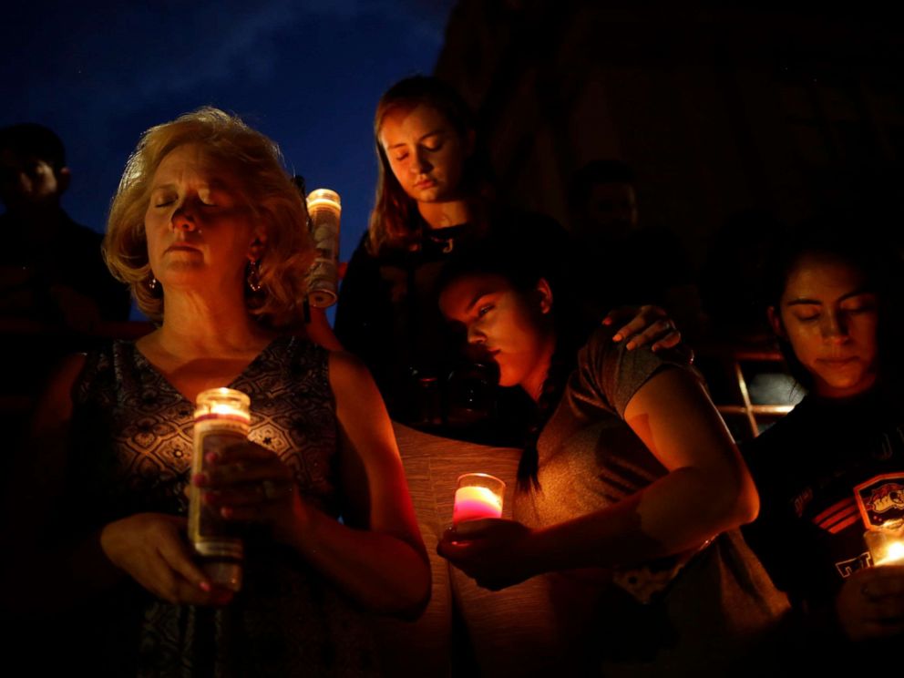 PHOTO: Mourners take part in a vigil at El Paso High School after a mass shooting at a Walmart store in El Paso, Texas, Aug. 3, 2019.