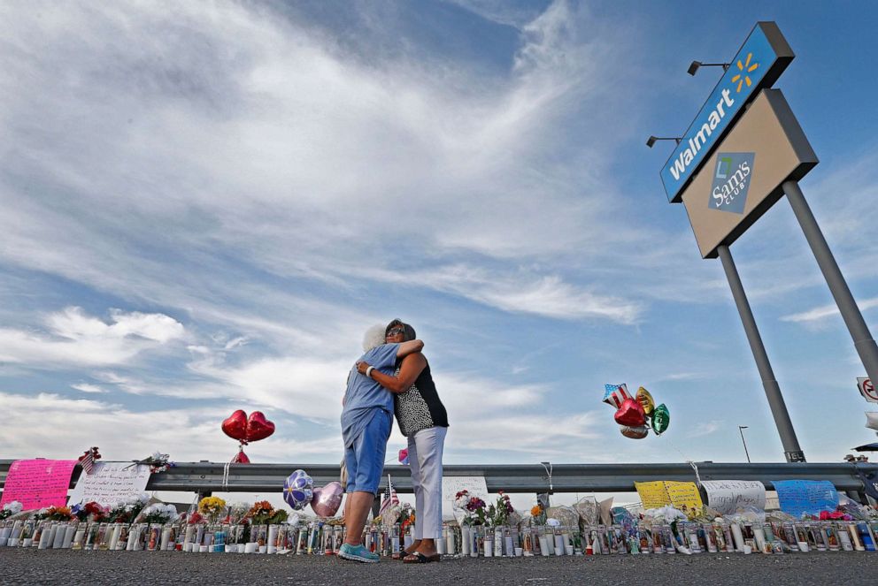 PHOTO: Two women hug while attending the make shift memorial along the street after the mass shooting at a Walmart in El Paso, Texas, Aug. 5, 2019.