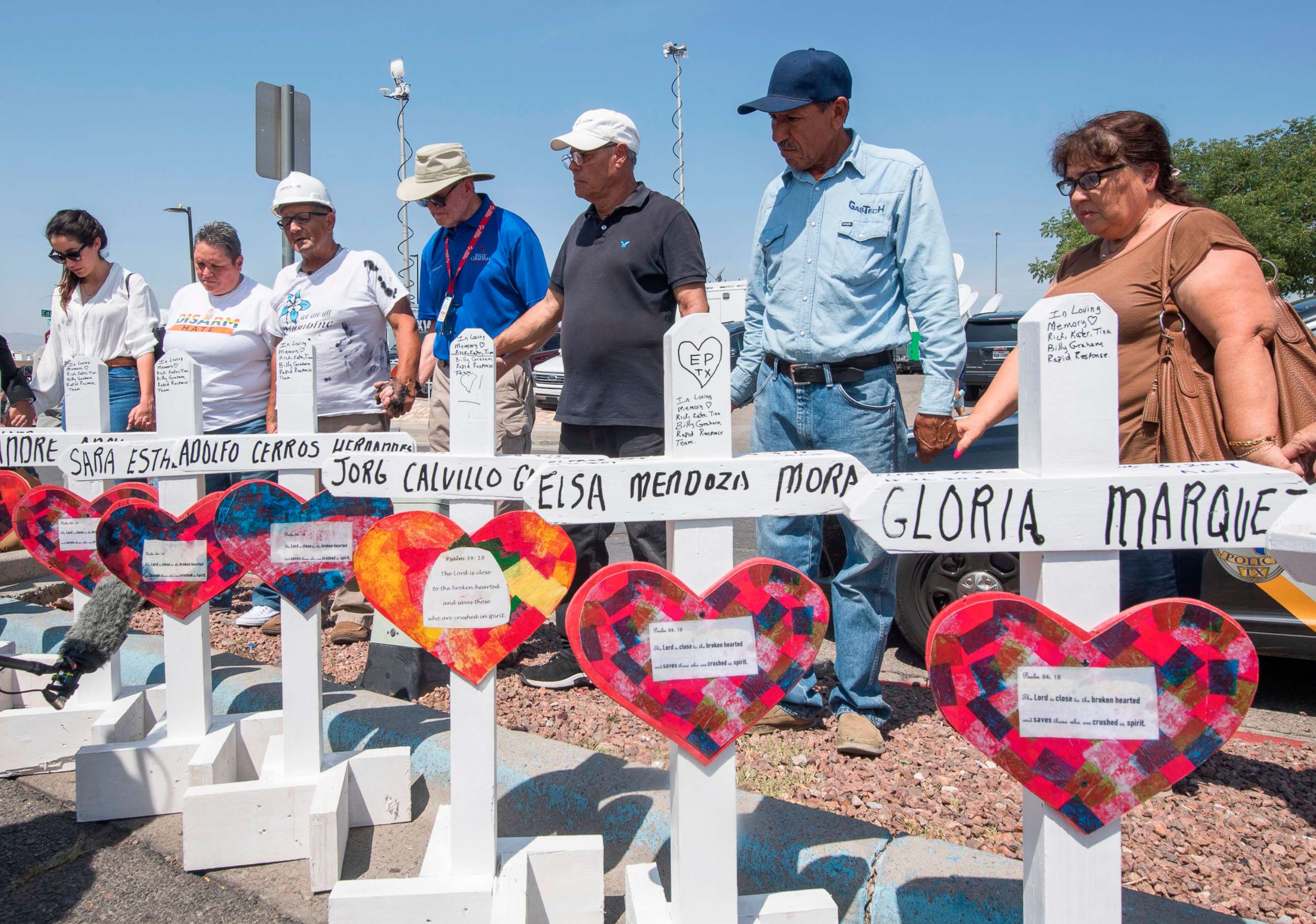 PHOTO: In this Aug. 5, 2019, file photo, people pray beside a makeshift memorial of crosses with the names of victims who died in the shooting at the Cielo Vista Mall Walmart in El Paso, Texas.