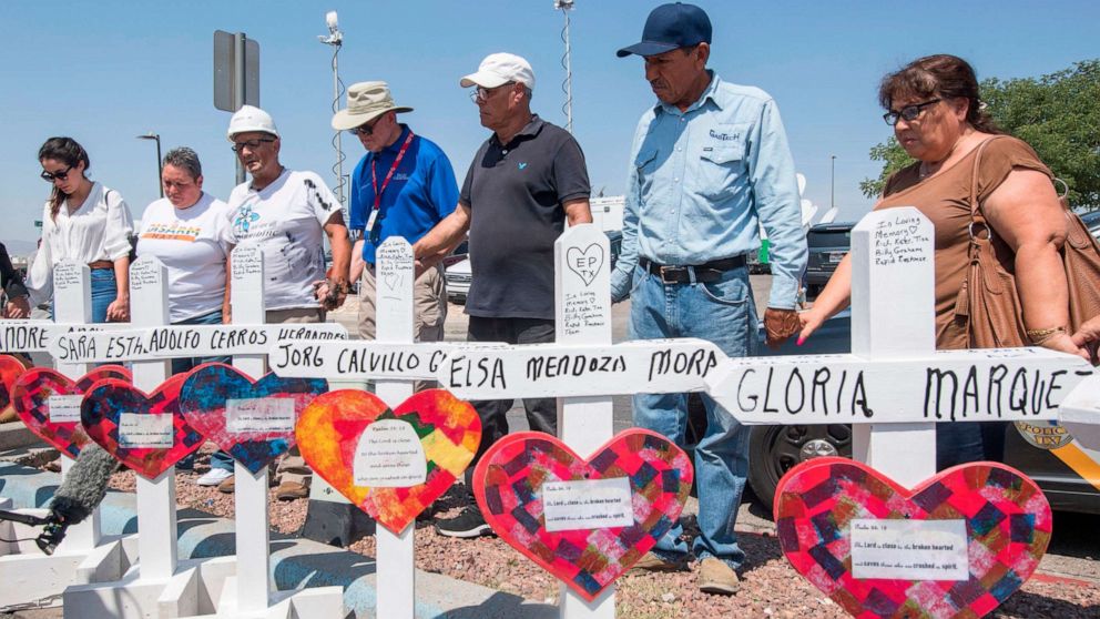 PHOTO: In this Aug. 5, 2019, file photo, people pray beside a makeshift memorial of crosses with the names of victims who died in the shooting at the Cielo Vista Mall Walmart in El Paso, Texas.