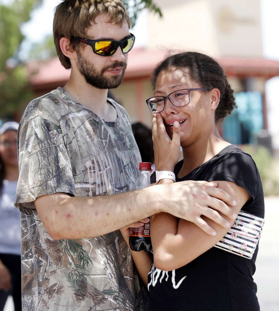 PHOTO: A man comforts a woman who was in the freezer section of a Walmart during a shooting incident, in El Paso, Texas, Aug. 03, 2019. 