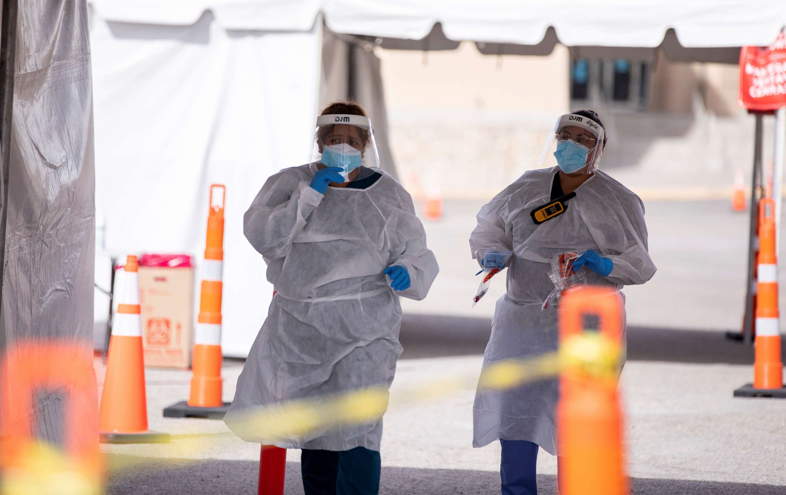 PHOTO: Medical personnel administer free COVID-19 tests at a state run drive-through testing site in the parking lot of the University of Texas, El Paso campus, in El Paso, Texas, U.S., Nov. 23, 2020.