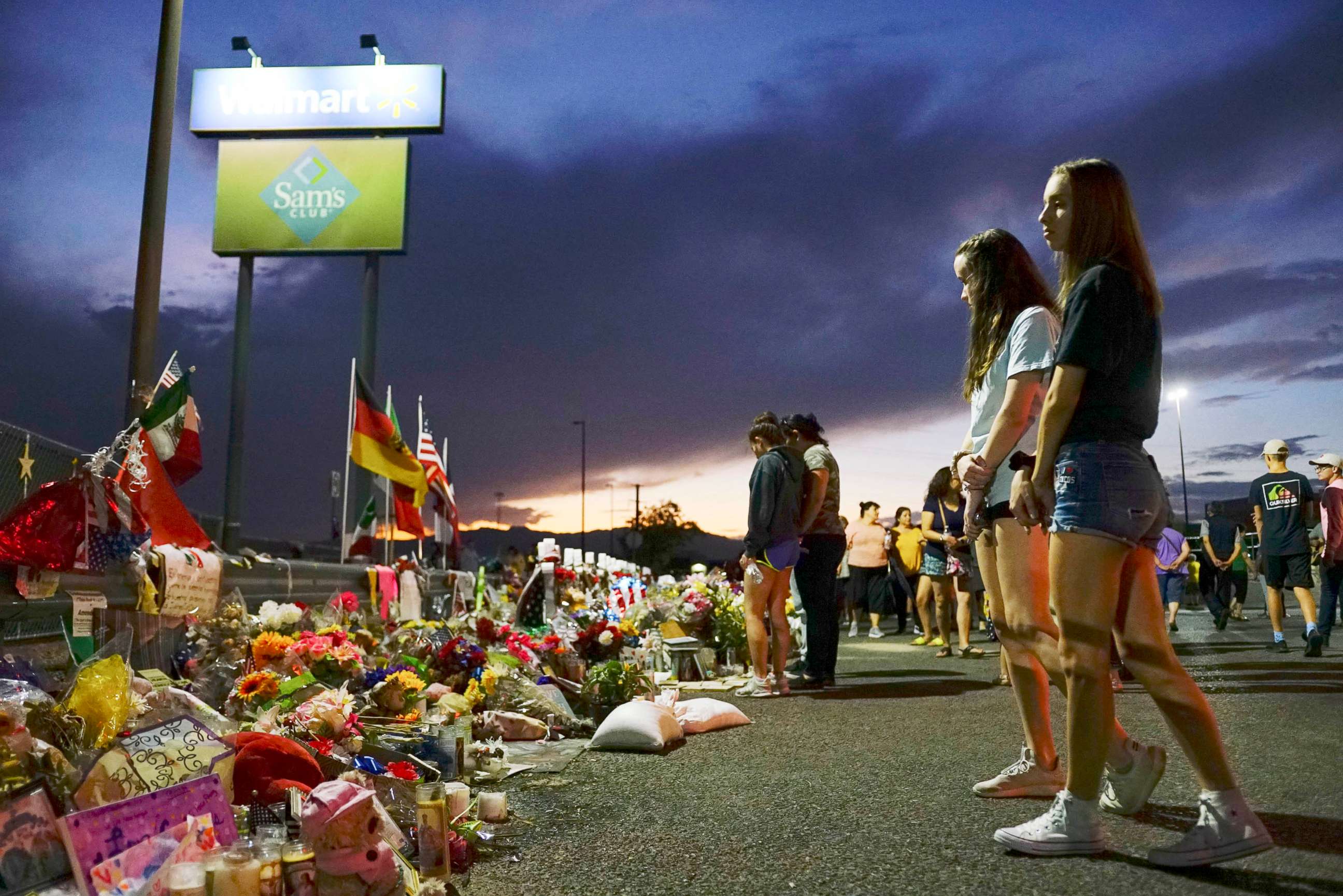 PHOTO: People gather at a makeshift memorial honoring victims outside Walmart in El Paso, Texas, Aug. 15, 2022.
