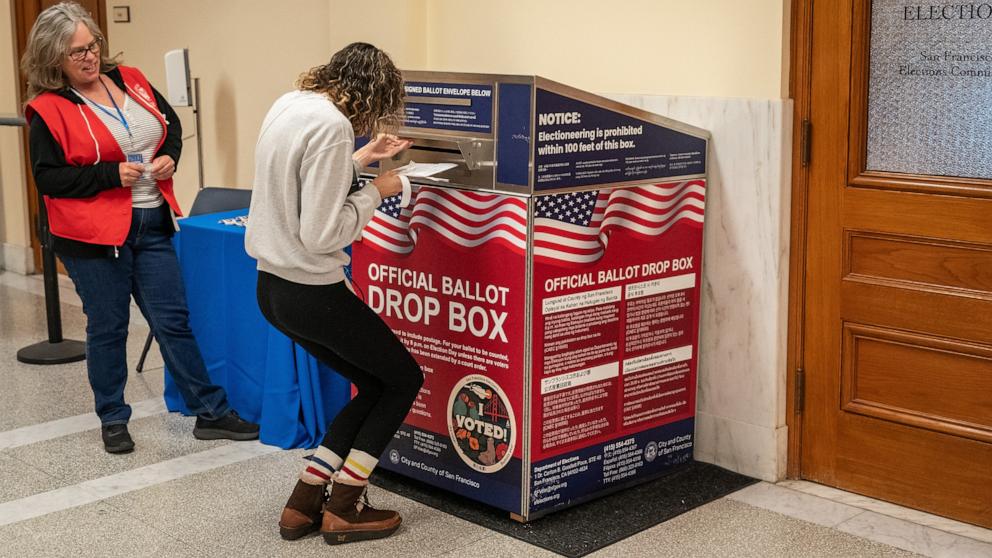 PHOTO: A voter drops off a ballot at an official ballot drop box at the San Francisco City Hall voting center on the final day of early voting ahead of Election Day, Nov. 4, 2024, in San Francisco.