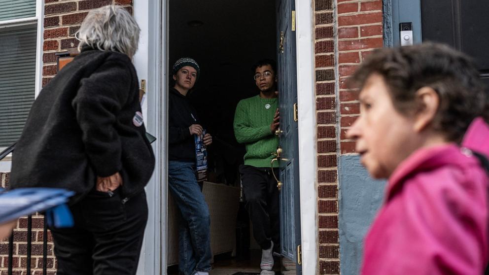 PHOTO: Kamala Harris campaign volunteers Vickie M. Feldman (R), and Kate Esposito speak to two people about voting locations and rules during a 'Get Out The Vote' effort two days before election day in Philadelphia, Pa., Nov. 3, 2024. 