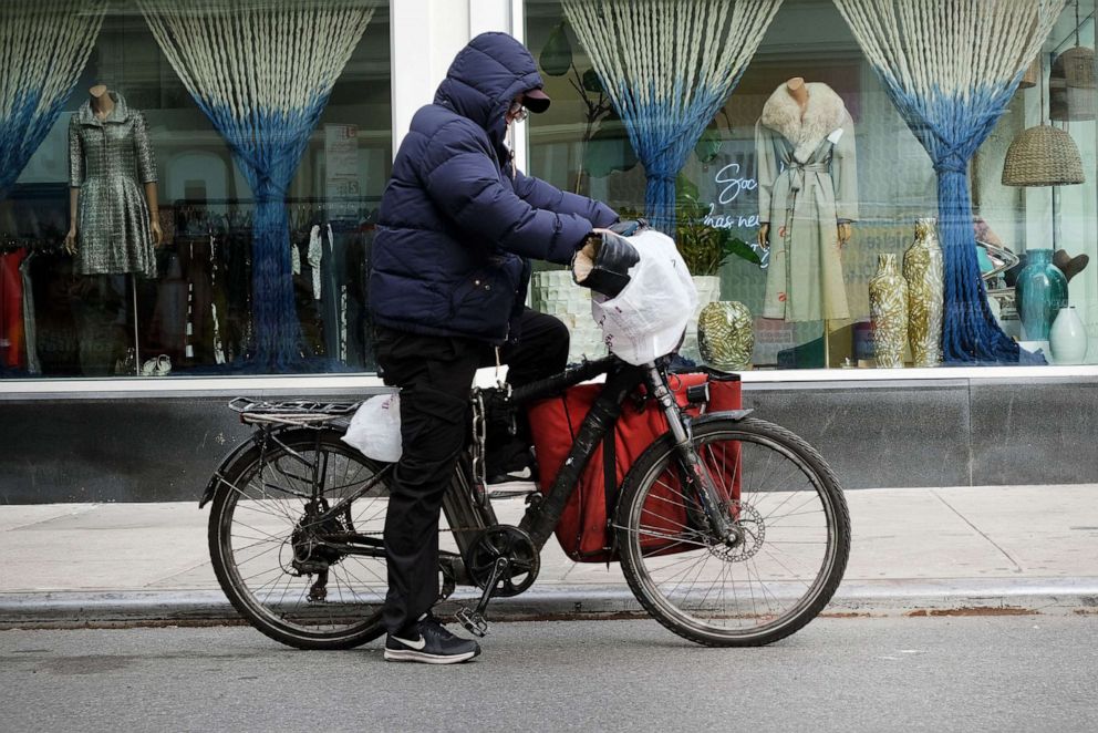 PHOTO: In this Nov. 15, 2022, file photo, a delivery person rides an electric bicycle through the streets of New York.