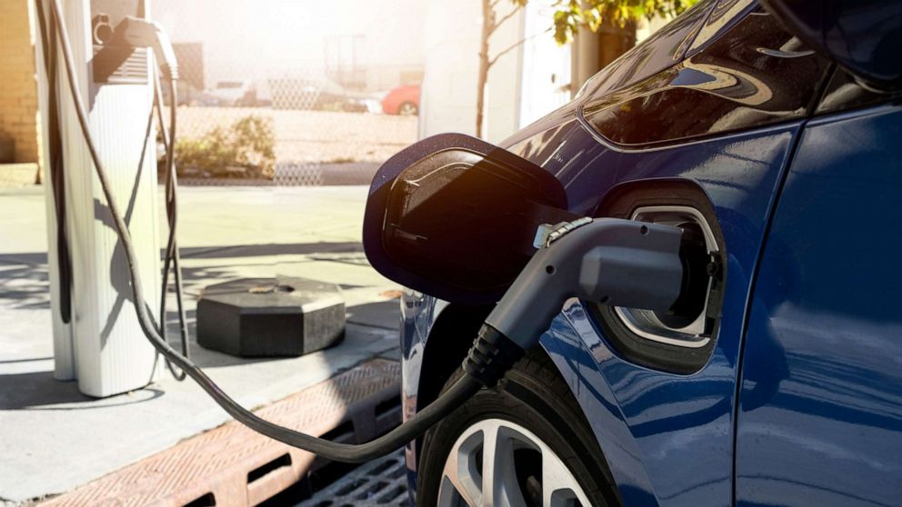 PHOTO: A car charges at an electric car recharging station.