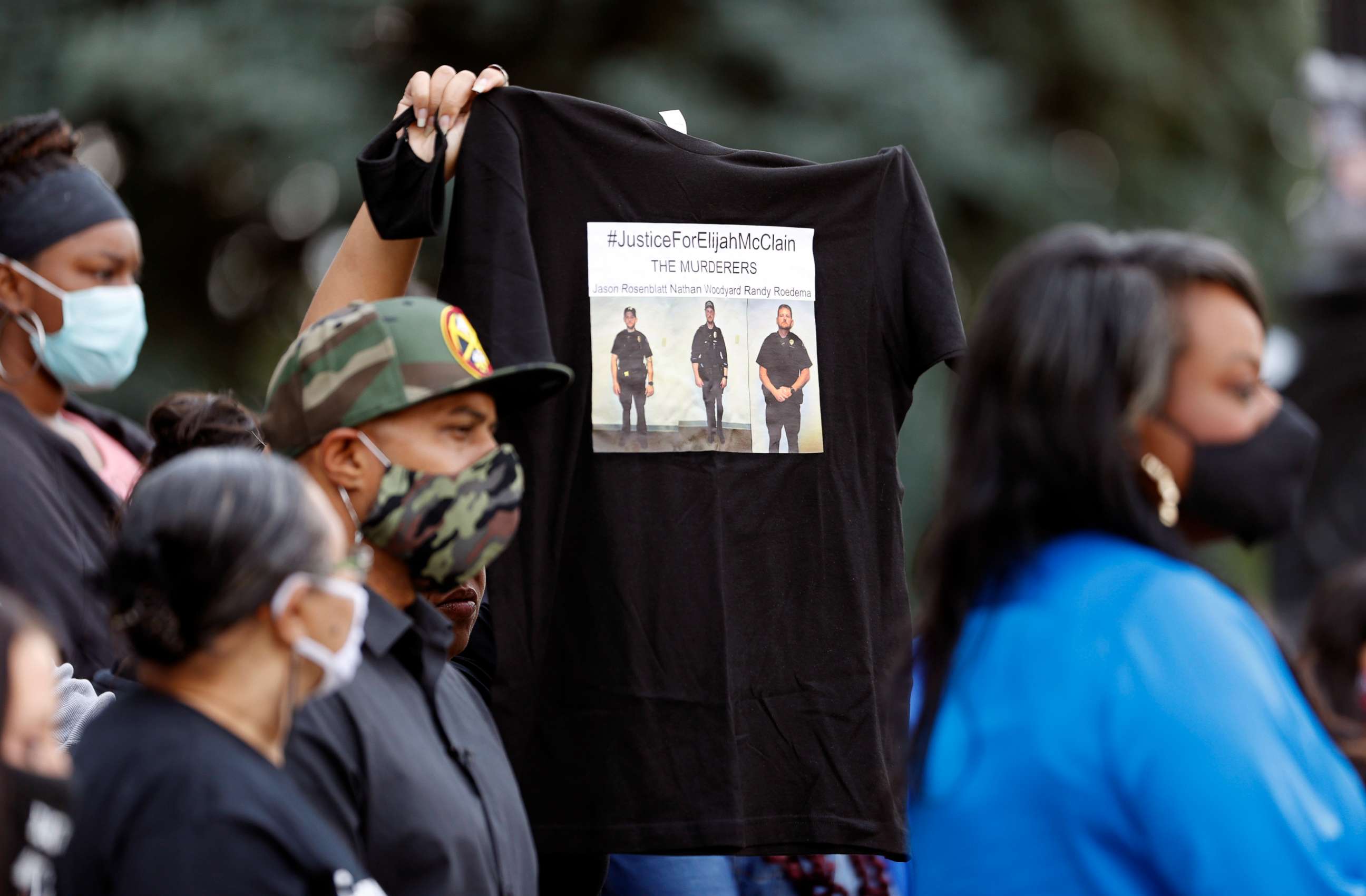 PHOTO: A supporter holds up a shirt to call attention to the death of Elijah McClain in August 2019 in Aurora, Colo., during a news conference after Gov. Jared Polis signed a broad police accountability bill Friday, June 19, 2020, in downtown Denver.