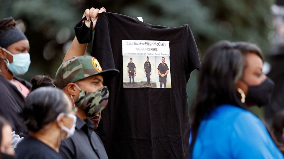 PHOTO: A supporter holds up a shirt to call attention to the death of Elijah McClain in August 2019 in Aurora, Colo., during a news conference after Gov. Jared Polis signed a broad police accountability bill Friday, June 19, 2020, in downtown Denver.