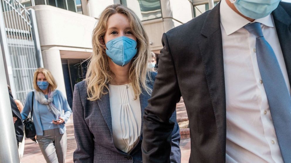 PHOTO: (FILES) In this file photo taken on Sept. 8, 2021 Elizabeth Holmes, founder and former CEO of Theranos, leaves the courthouse with her husband, Billy Evans after the first day of her fraud trial in San Jose, California.