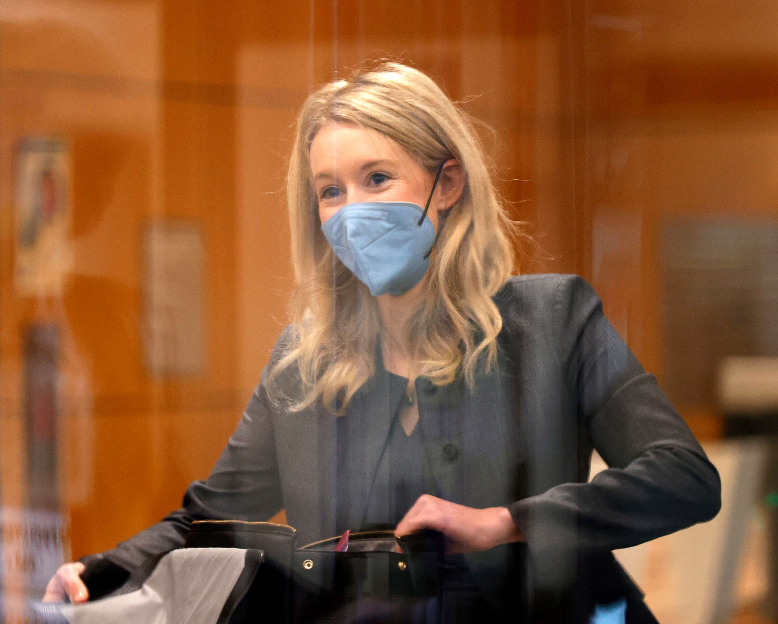 PHOTO: Theranos founder and former CEO Elizabeth Holmes goes through a security checkpoint as she arrives for her trial at the Robert F. Peckham Federal Building on Nov. 17, 2021, in San Jose, Calif.