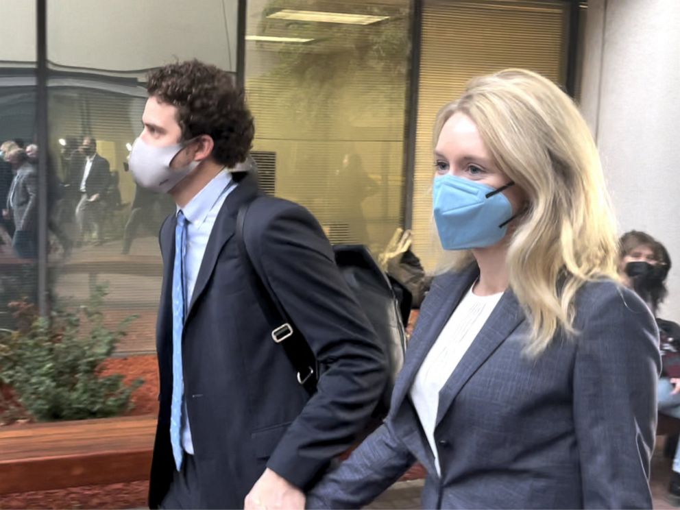 PHOTO: Elizabeth Holmes and her partner Billy Evans leave court Friday after Holmes' first day of testimony in her criminal fraud trial. Nov. 19, 2021.