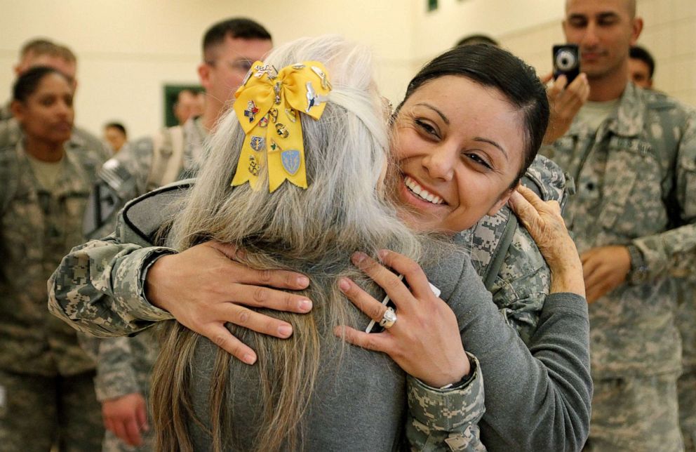 PHOTO: Elizabeth Laird of Copperas Cove, known as the "Hug Lady" at Fort Hood, hugs a soldier as others wait to be next during the homecoming of the 3rd Brigade, 1st Cavalry Division at Fort Hood, Texas, Dec. 21, 2011.