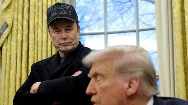 Elon Musk listens to President Donald Trump speak in the Oval Office of the White House in Washington, Feb. 11, 2025.   