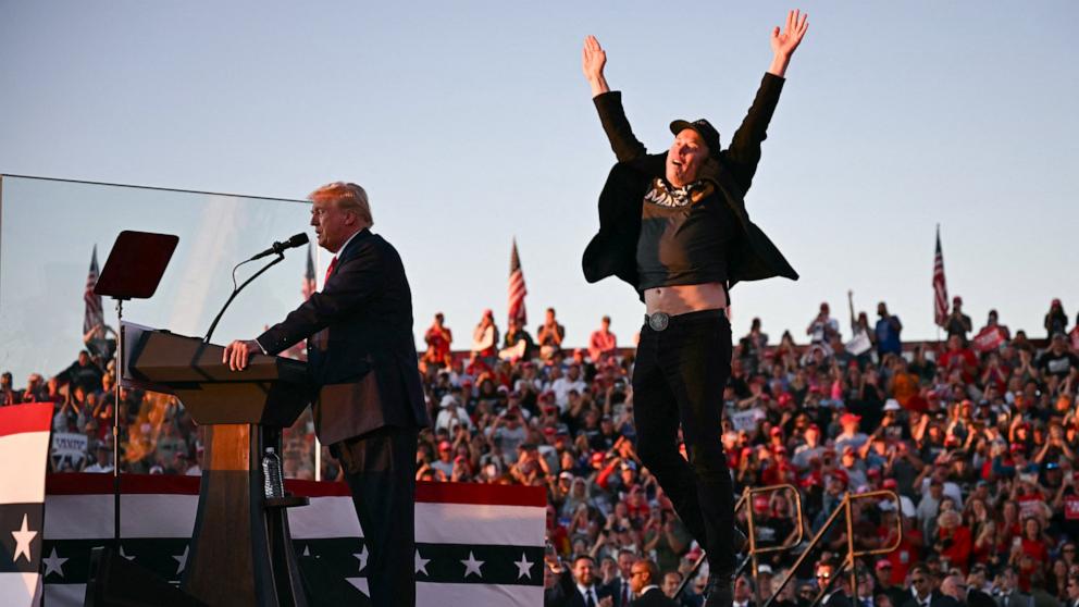 PHOTO: Tesla and SpaceX CEO Elon Musk jumps on stage as he joins former US President and Republican presidential candidate Donald Trump during a campaign rally in Butler, Pennsylvania, Oct. 5, 2024. 