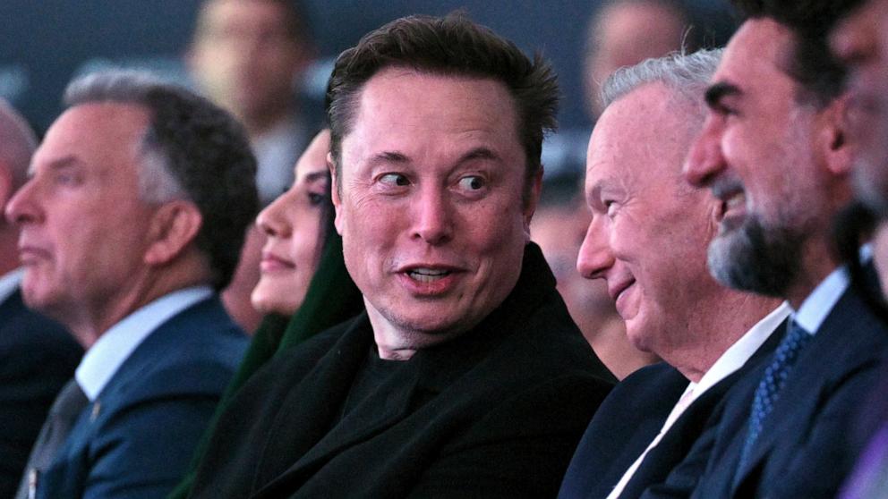 PHOTO: Elon Musk talks talks with former Google CEO Eric Schmidt as President Donald Trump speaks at the Future Investment Initiative Institute summit in Miami Beach, Fla., Feb. 19, 2025.