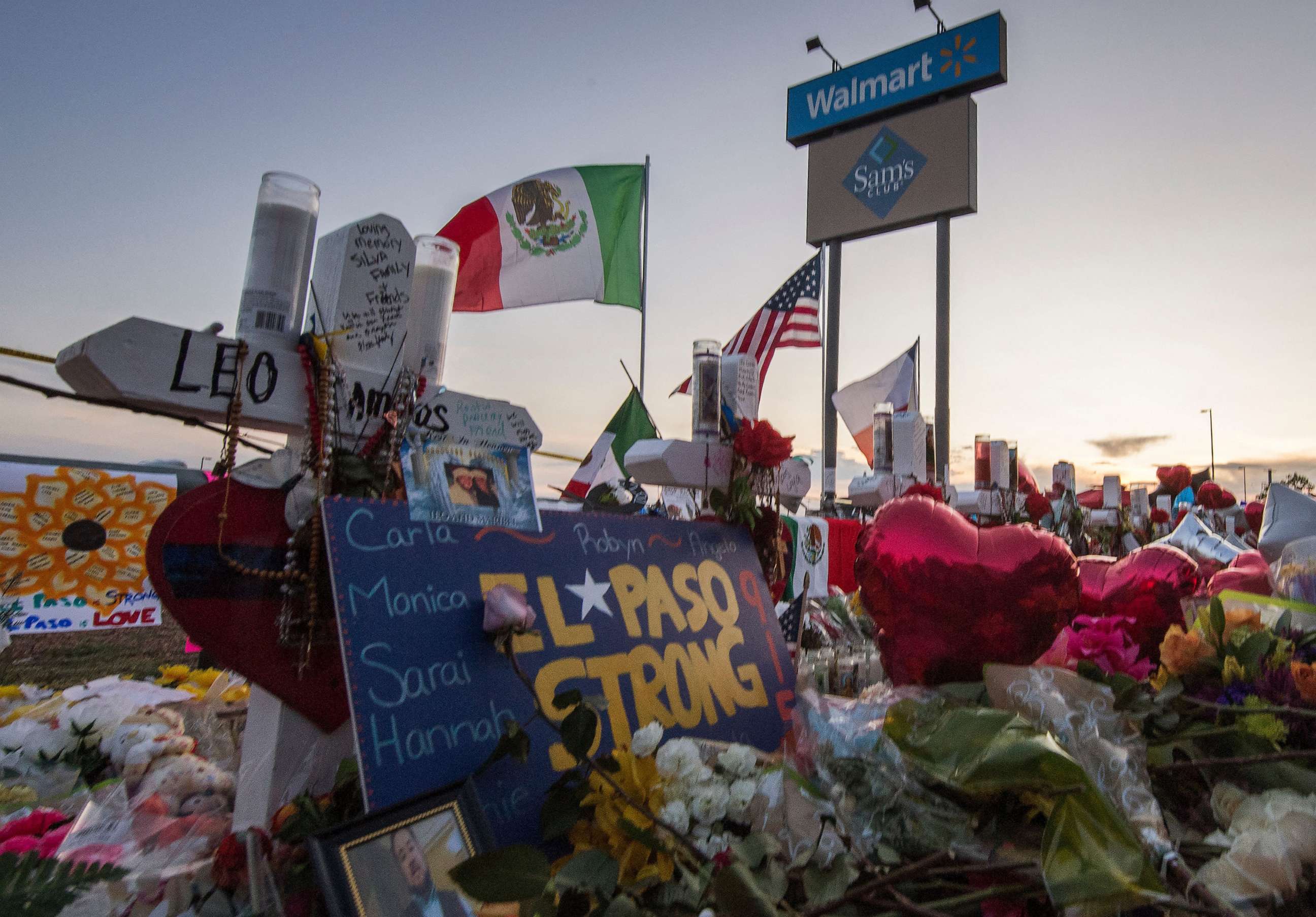 PHOTO: A makeshift memorial for victims of the shooting that left a total of 22 people dead at the Cielo Vista Mall WalMart (background) in El Paso, Texas, Aug. 6, 2019.