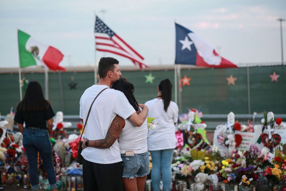 PHOTO: People gather at a makeshift memorial honoring victims outside of Walmart, Aug. 15, 2019, in El Paso, Texas.