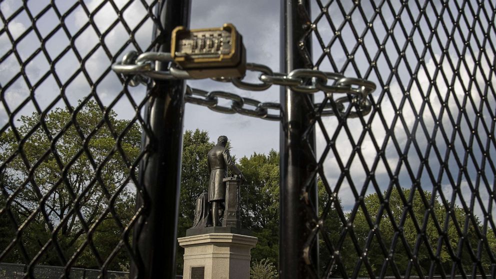 PHOTO: *A locked gate surrounds the Emancipation Memorial debate in Lincoln Park, June 26, 2020, in Washington, D.C., to protect it as controversy and protests erupted around monuments that many find offensive.
