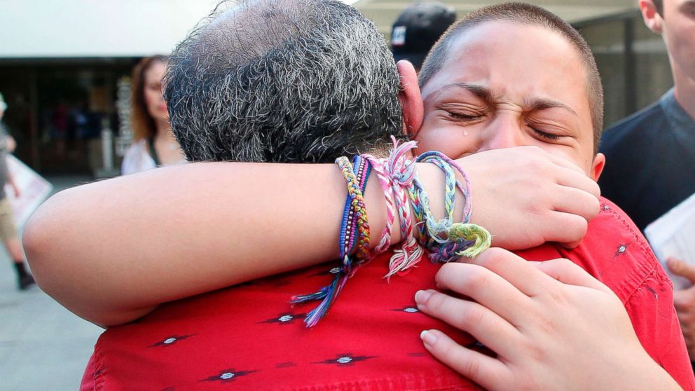 Marjory Stoneman Douglas High School student Emma Gonzalez hugs her father Jose after speaking at a rally for gun control at the Broward County Federal Courthouse in Fort Lauderdale, Fla., Feb. 17, 2018.